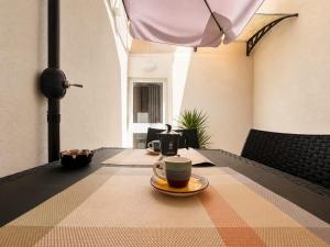 a cup of coffee sitting on top of a table at La Pola House Cagliari in Cagliari