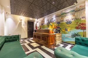 a room with a piano and a mural on the wall at The Saga Hotel Green Park in New Delhi
