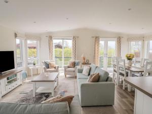 a living room with a couch and a table at Hazelwood 3 in Lyme Regis