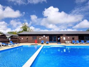 a large swimming pool in front of a building at Hazelwood 3 in Lyme Regis
