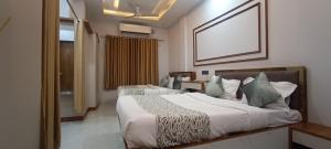 a hotel room with a bed with a picture on the wall at Savanna Farm in Nagpur