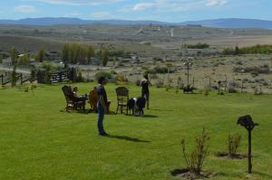 a group of people standing in a field with a dog at Cabañas Teuepen in El Calafate
