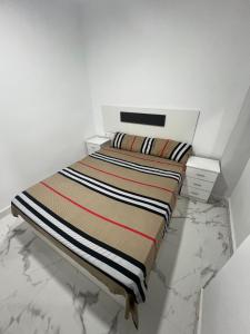 a bed in a white room with at Gandía Jacuzzi Suites in Gandía