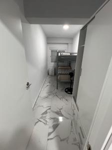 a hallway with a marble floor and a bed at Gandía Jacuzzi Suites in Gandía