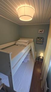 a large bed in a room with a light at Örnen' in Undenäs