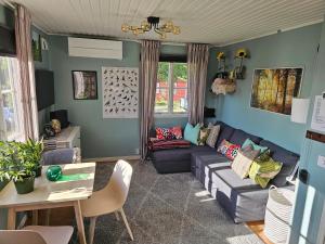 a living room with a couch and a table at Örnen' in Undenäs