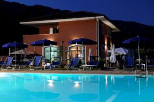 a villa with a swimming pool at night at Villa Cilento, PISCINA CAMERE APPARTAMENTI & RISTORANTE in Capaccio-Paestum