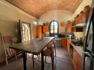 a kitchen with a wooden table and chairs in it at Villa Bouchra in Marrakesh