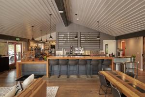 a restaurant with a bar with leather chairs and tables at Trailhead Lodge in Bend