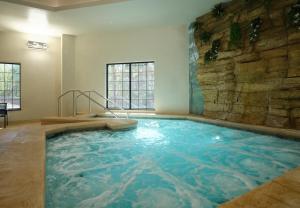 a large indoor pool with a stone wall at Dellshire Resort in Wisconsin Dells