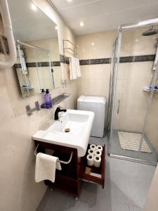 a bathroom with a sink and a shower at Milano Suite in Lev Eilat in Eilat +23 photos