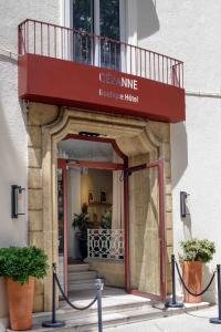 a front door of a building with a balcony at Hôtel Boutique Cézanne centre Aix-en-Provence in Aix-en-Provence