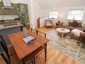 a living room with a table and a couch at Gews Farm Lodge in Penzance