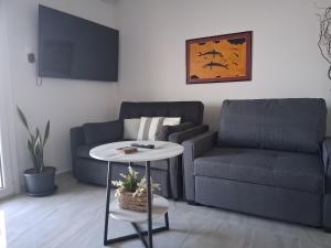 a living room with a couch and a table at Katrin chios in Chios