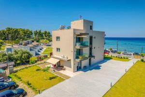 an aerial view of a white house with the ocean at Filian Apartments in Neos Marmaras