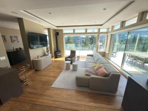 a living room with a couch and a large window at Bowen Island Ocean Retreat in Bowen Island