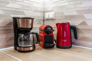 two coffins and a coffee maker on a counter at Sea Front Panorama Villa Private Pool in Agia Pelagia