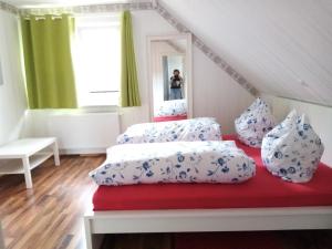 a bedroom with two beds and a mirror at Haus Martin in Kurort Steinbach-Hallenberg