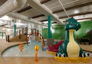 a childrens play area with a dinosaur in a pool at Dellshire Resort in Wisconsin Dells