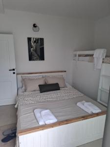 a bed in a room with two towels on it at Apartmani Emma II in Gobovići