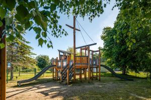 a playground in a park with a slide at Gamtos Perlas in Karklė