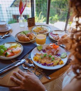 a table with plates of food on it at Papangue Hôtel & Spa in Étang-Salé