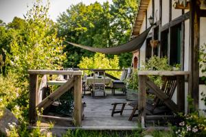 a wooden deck with a table and chairs on a house at Koń na biegunach in Glaznoty