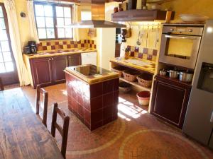 a kitchen with a table and a stove top oven at maison florentine in La Gaude