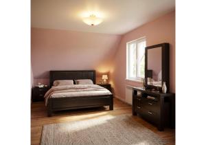 a bedroom with a bed and a dresser and a mirror at Forest Edge Guesthouse in Aghavnadzor