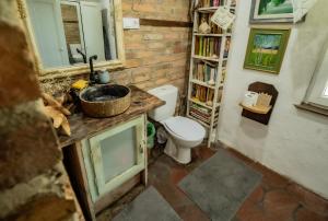 a bathroom with a toilet and a book shelf at Koń na biegunach in Glaznoty +27 photos