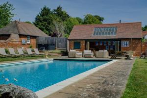 a swimming pool in the backyard of a house at Abbey House by Group Retreats in Saffron Walden