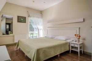 a bedroom with a large bed and a window at Gamtos Perlas in Karklė