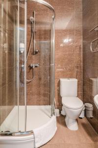 a bathroom with a toilet and a glass shower at Gamtos Perlas in Karklė +117 photos