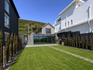 ein Garten mit Rasen vor einem Gebäude in der Unterkunft Beach House in Croyde
