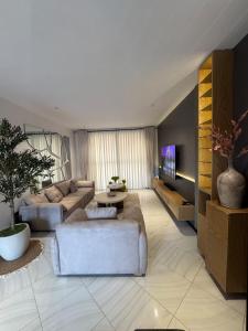 a living room with a couch and a table at Home in Naalya in Kampala
