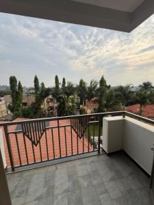 a balcony with a view of palm trees at Home in Naalya in Kampala