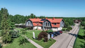 a large house with cars parked in the driveway at Gamtos Perlas in Karklė