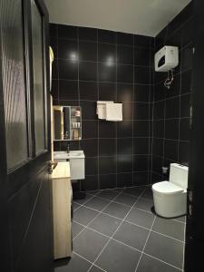 a bathroom with a toilet and a sink at Home in Naalya in Kampala +41 photos