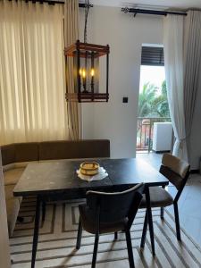 a living room with a table and a couch at Home in Naalya in Kampala