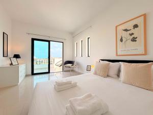 a large white bedroom with a large white bed at Ultimate Group Getaway Near St Julian's & Seafront in San Ġwann +93 photos