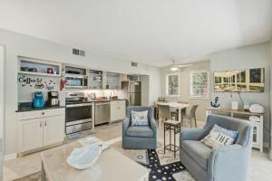 a kitchen and living room with two chairs and a table at Seascape 3522 in Kiawah Island