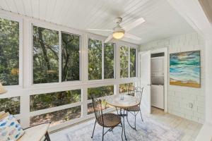 a dining room with windows and a table and chairs at Seascape 3522 in Kiawah Island