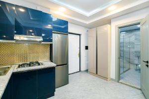 a kitchen with blue cabinets and a glass door at Bea Paradise 112 in Baku +31 photos