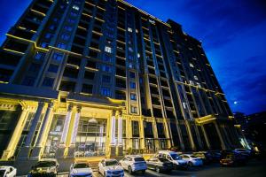 a large building with cars parked in front of it at Bea Paradise 112 in Baku