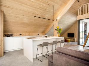 a kitchen with a white island in a room at Villa WOOD in Elsendorp