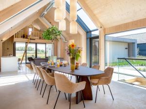 a dining room with a table and chairs at Villa WOOD in Elsendorp