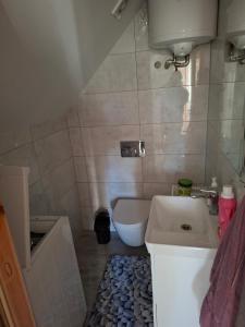 a small bathroom with a sink and a toilet at Dom Trakt Słupski Sulęczyno in Sulęczyno +20 photos