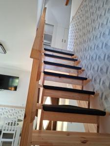 a wooden staircase in a room with a wall at Dom Trakt Słupski Sulęczyno in Sulęczyno
