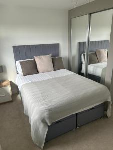 a bedroom with a large bed and a mirror at House of Berry in EDI