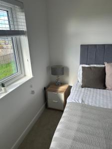 a bedroom with a bed next to a window at House of Berry in EDI +5 photos